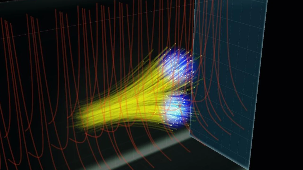 A wave packet and its Bohmian particle trails split into two branches in a three-dimensional Stern–Gerlach field.